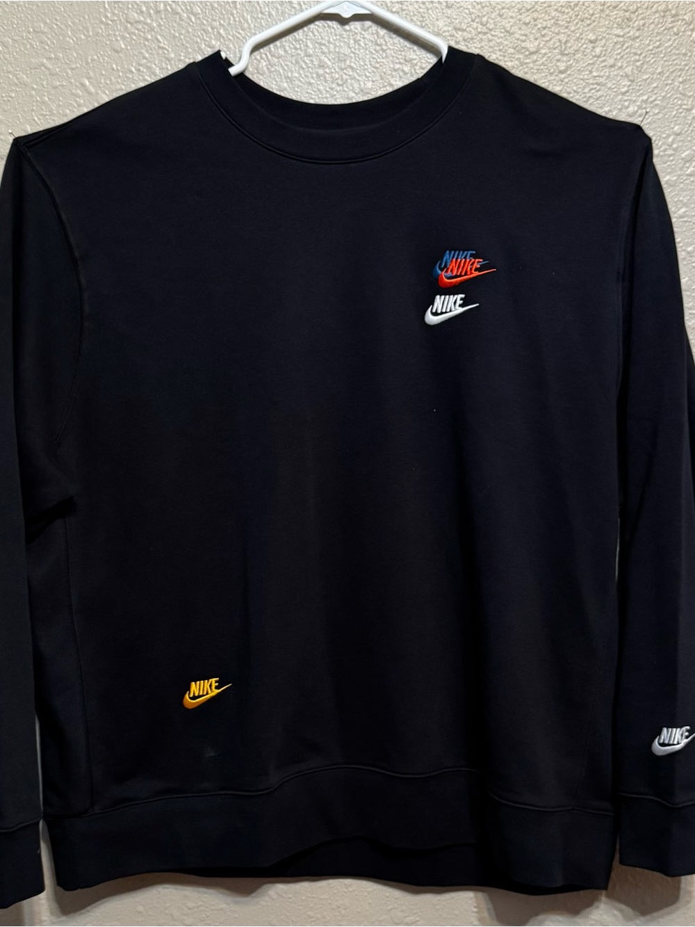 Nike Black Crewneck Sweatshirt with Red, Blue, White, and Gold Logos